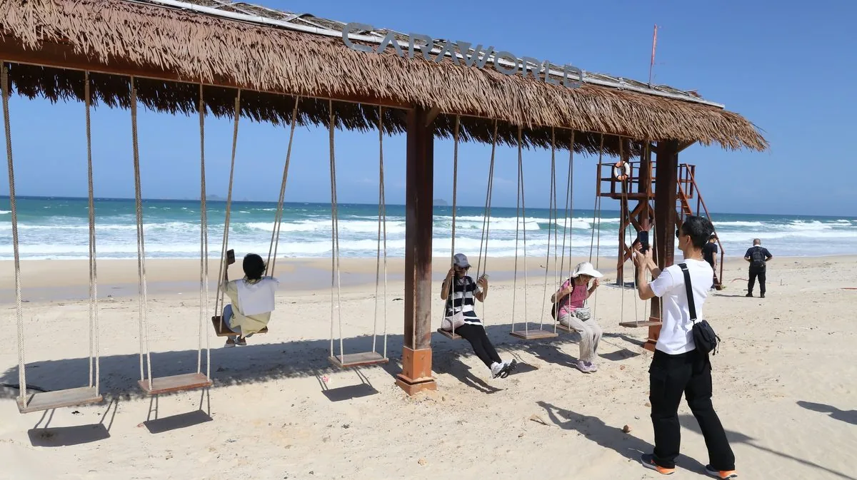 Du khách trải nghiệm xích đu mái tranh hướng biển tại bãi biển CaraWorld Cam Ranh